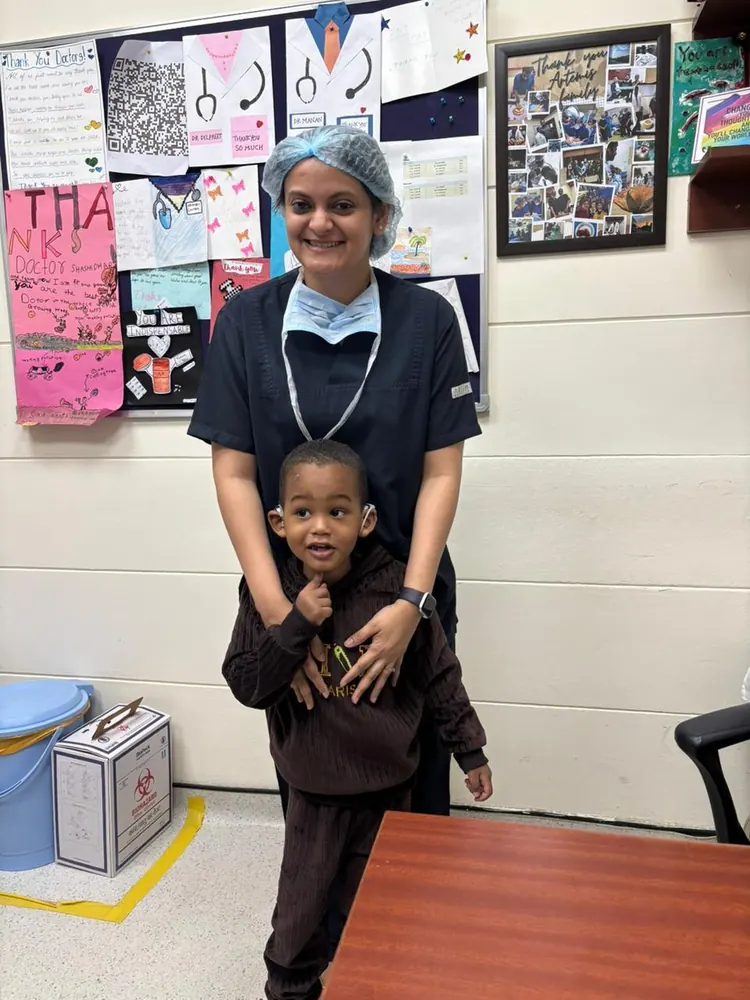 Dr. Trisha Srivastava with a young patient in the ENT OPD